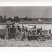 Three Men on Farm Tractors at Harvest Time